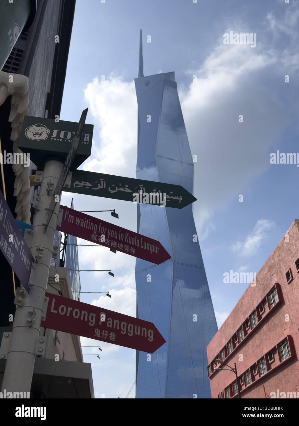 Merdeka Sign View of colorful signs pointing in different directions with the ...