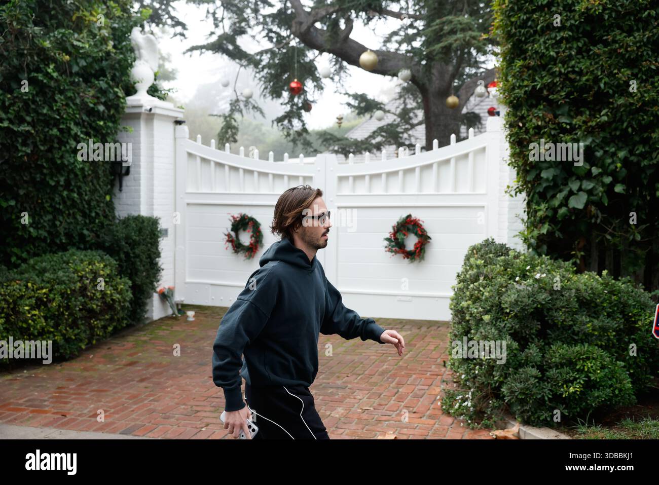 Rocco, who identified himself as Rob Reiner's assistant, walks outside ...