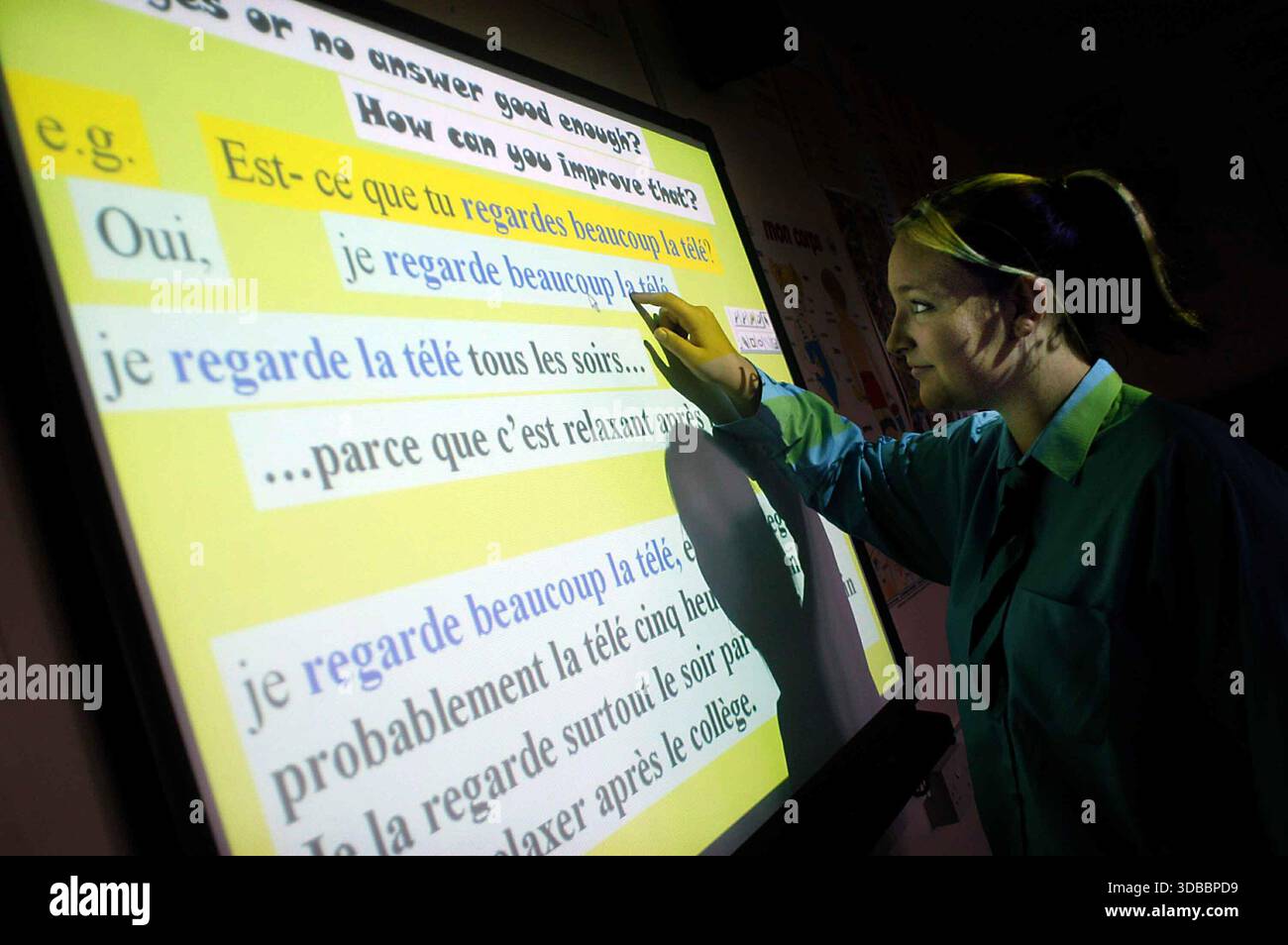 School pupils in a class using an interactive white board. Stock Photo