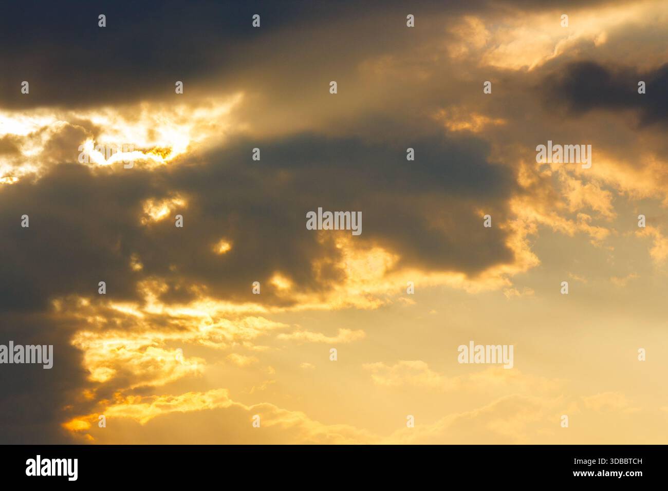 dramatic sunset sky with clouds. beautiful nature background in golden evening light. telephoto shot. leadership corporate wallpaper Stock Photo