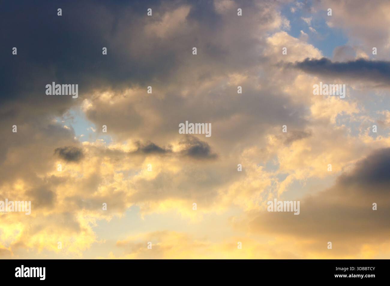 dramatic sunset sky with clouds. beautiful nature background in golden evening light. telephoto shot. leadership corporate wallpaper Stock Photo