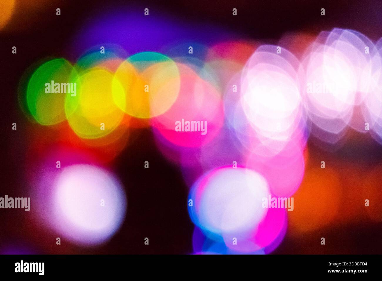 christmas tree bokeh lights. new year abstract background. decorated festive winter holiday backdrop. de focused urban landscape of uzhhorod dark stre Stock Photo