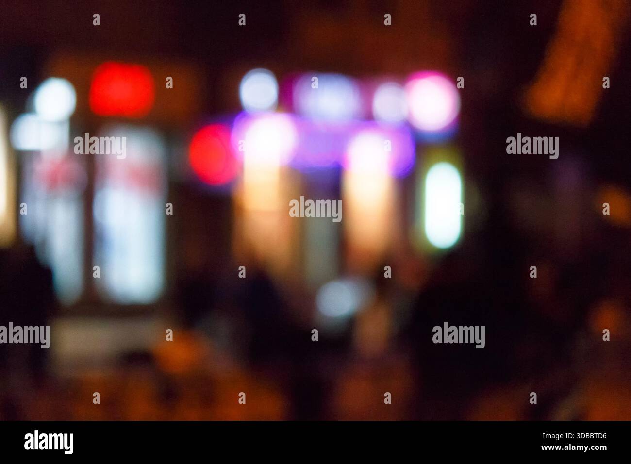 christmas tree bokeh lights. new year abstract background. decorated festive winter holiday backdrop. de focused urban landscape of uzhhorod dark stre Stock Photo