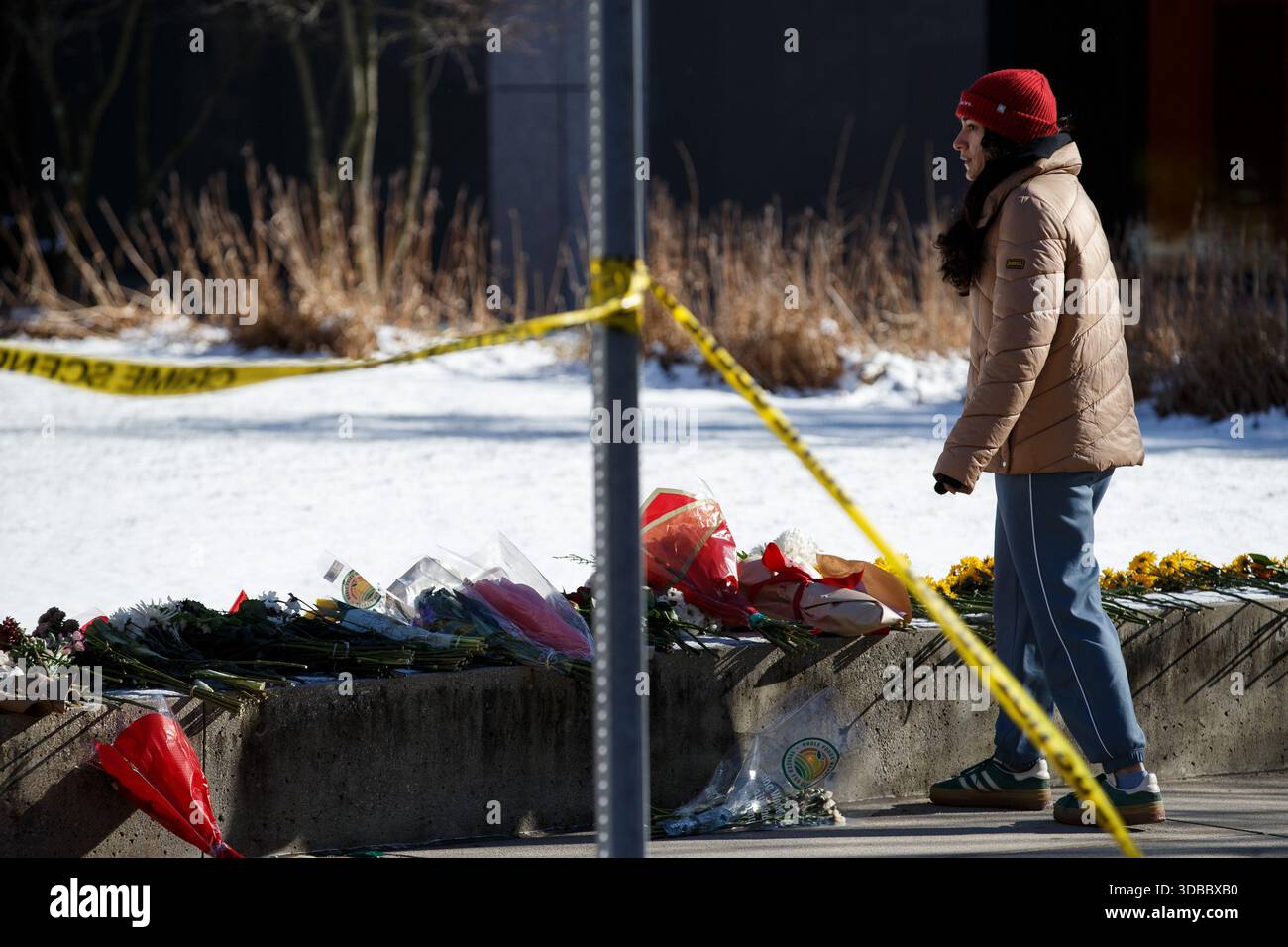 Providence, United States. 15th Dec, 2025. A woman stops to pay ...