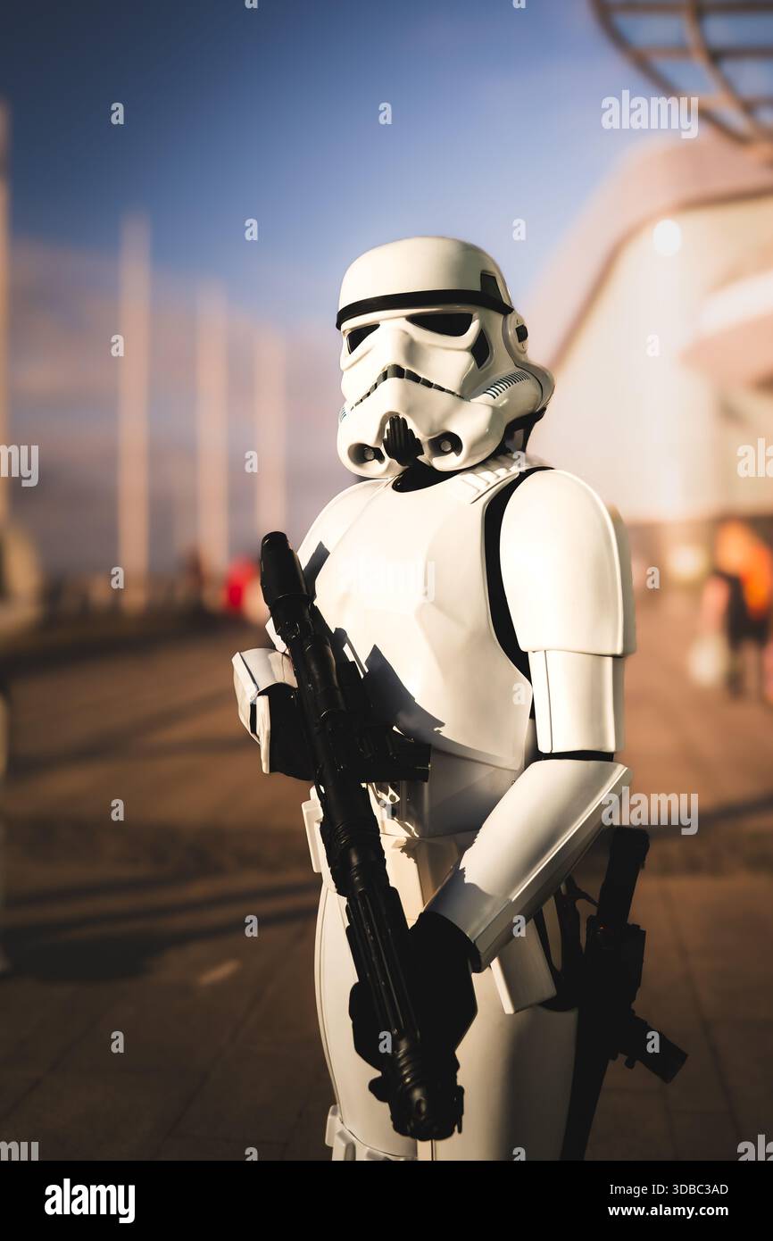 LIVERPOOL, UK - NOVEMBER 16, 2025. Dramatic vertical portrait of a male cosplayer dressed as and Imperial Star Wars Stormtrooper in an urban envionmen Stock Photo