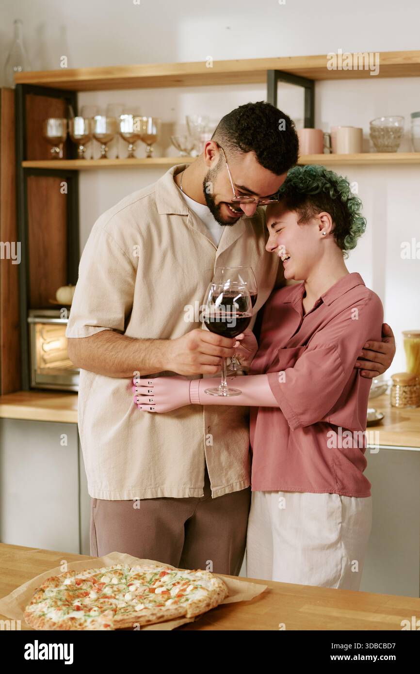 Young Woman with Prosthetic Arm Hugging Young Man Smiling Stock Photo ...