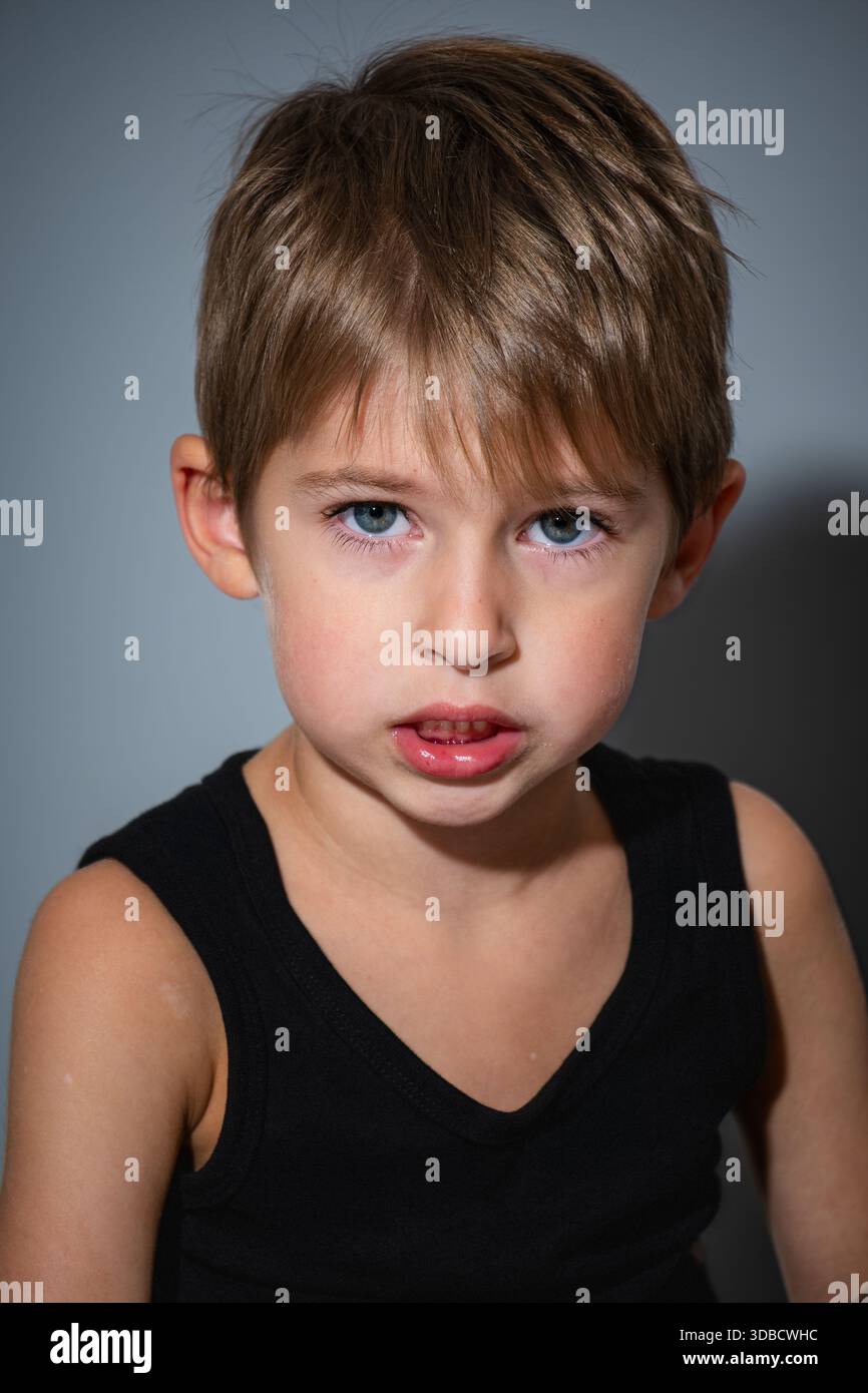 Intense Boy Portrait, Closeup Of Determined Boy Under Stark Lighting Stock Photo