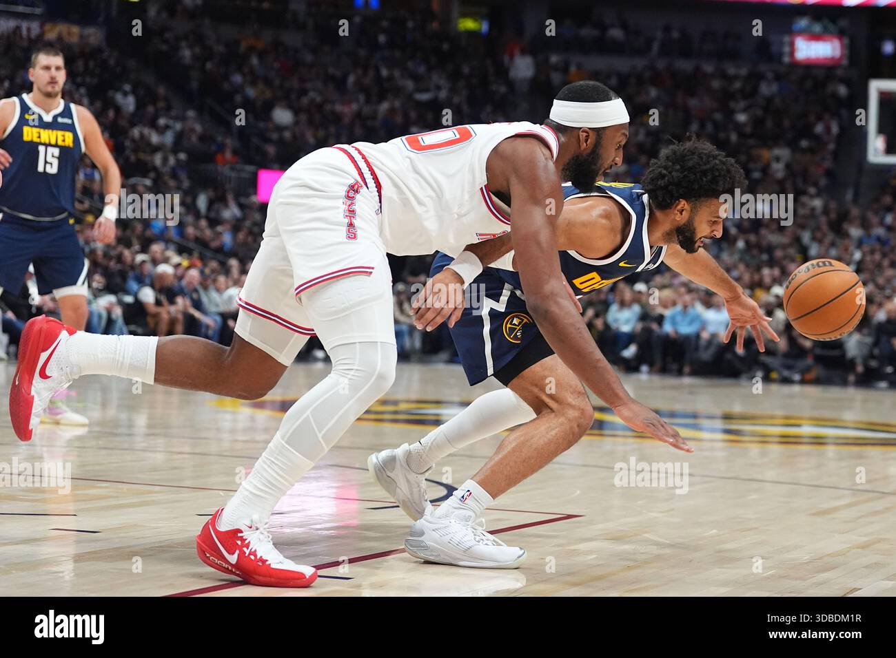 Houston Rockets guard Josh Okogie, front left, and Denver Nuggets guard ...