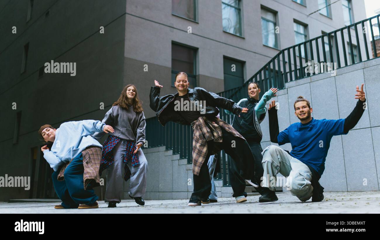 Hip hop group moving in sync during outdoor practice. Stock Photo