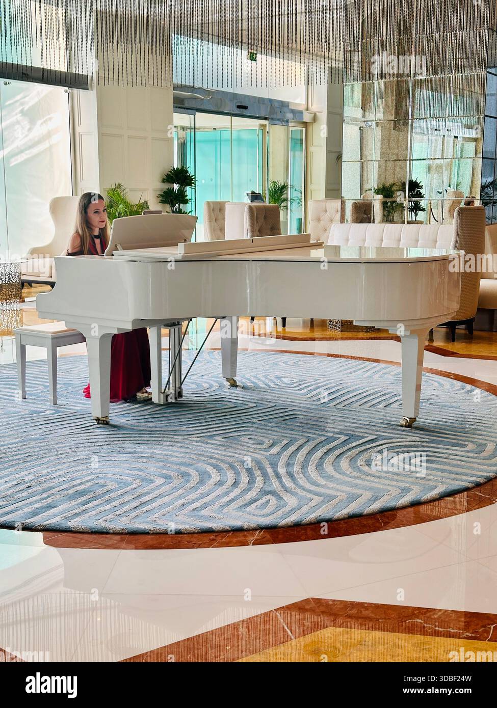 pianist playing the piano lobby bar Waldorf Astoria Hotel Ras al Khaimah - Smartphone Captured Stock Image