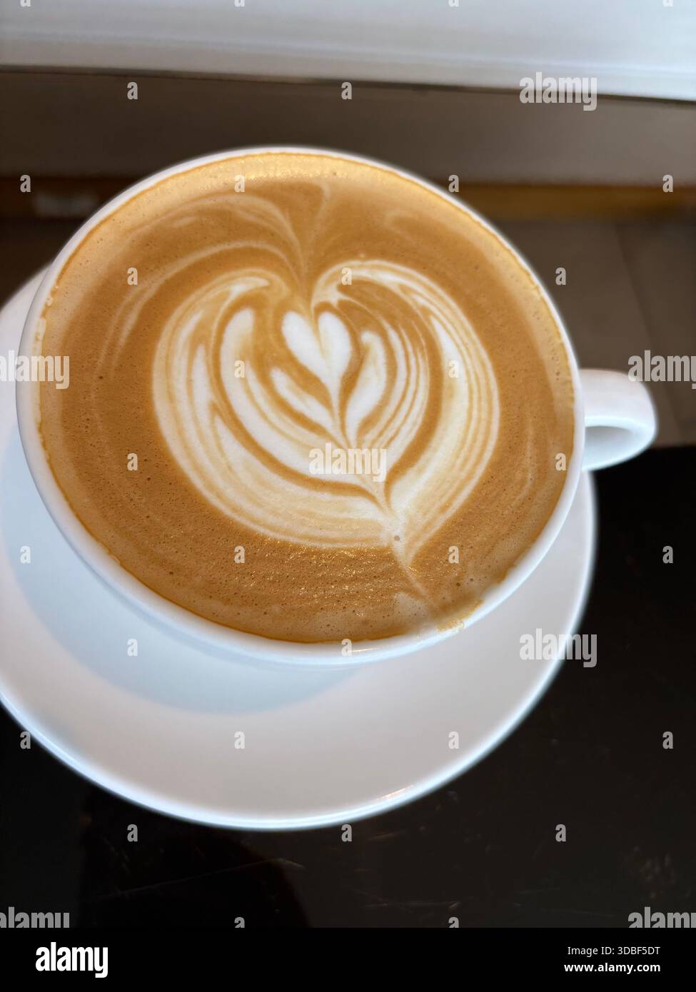 A cup of latte with a latte art - Smartphone Captured Stock Image