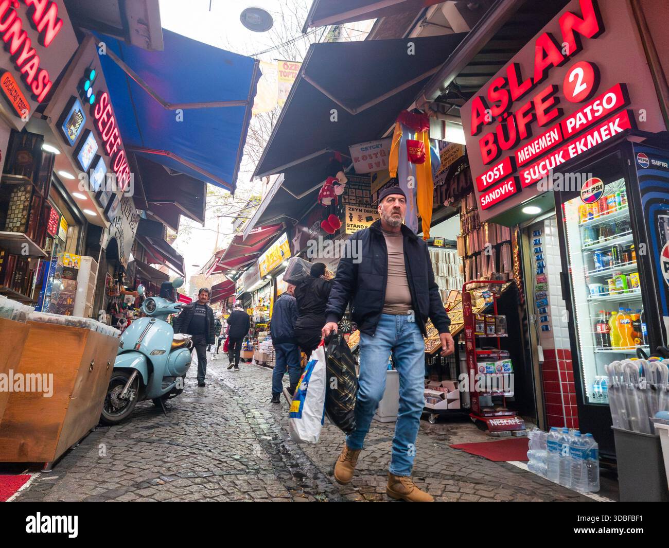 Istanbul, Turkey - 8th December, 2025, Man walking on a cobbled street ...