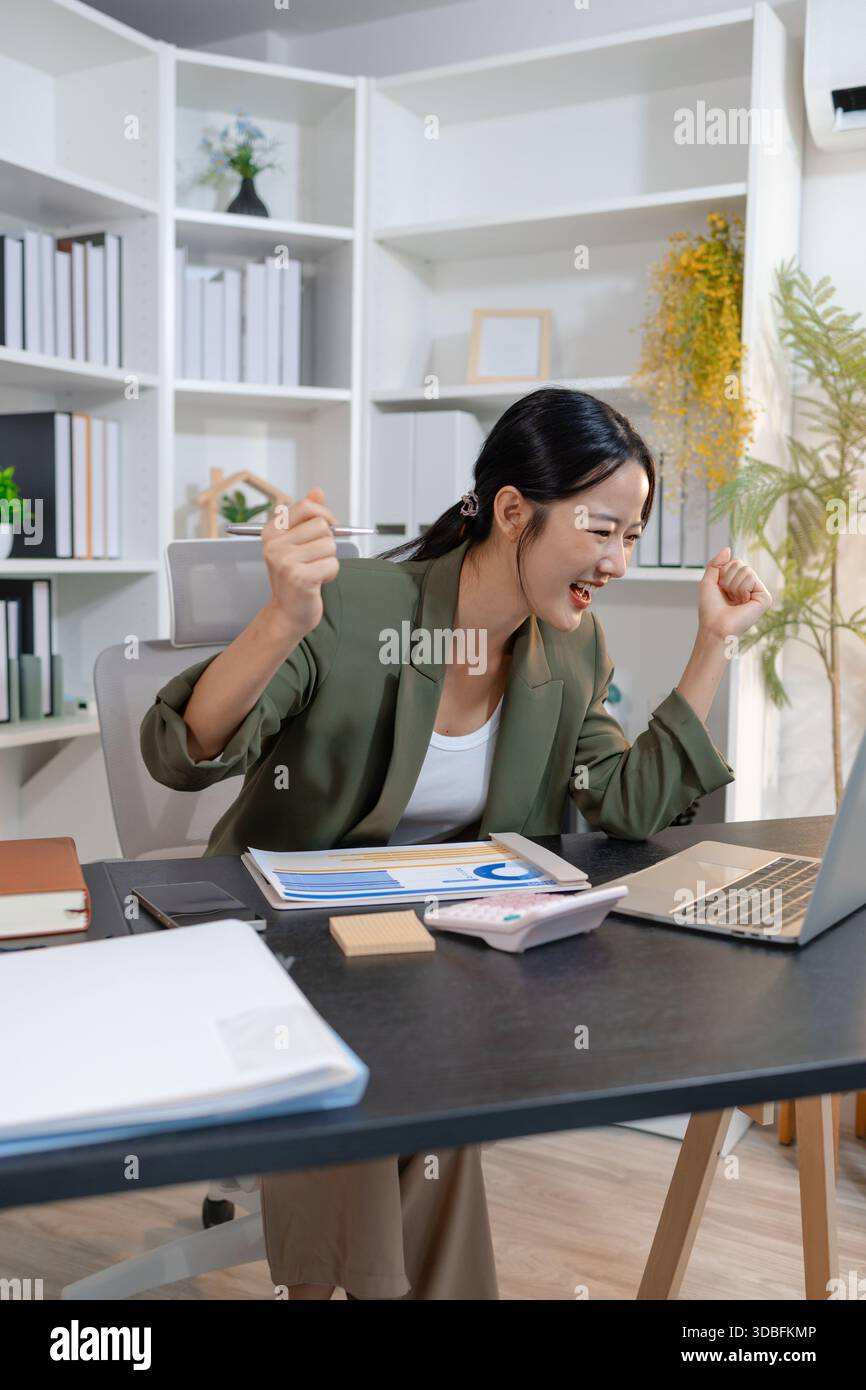 Professional businesswoman reviewing financial reports and taking notes ...