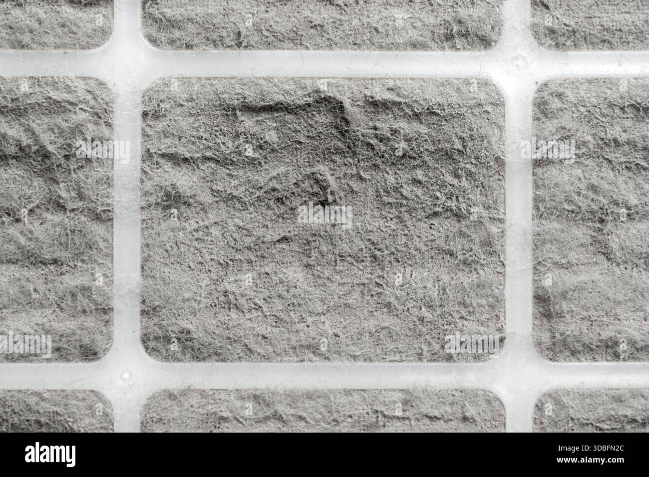 Dusty dirty air filter with plastic frames. Abstract gray background Stock Photo