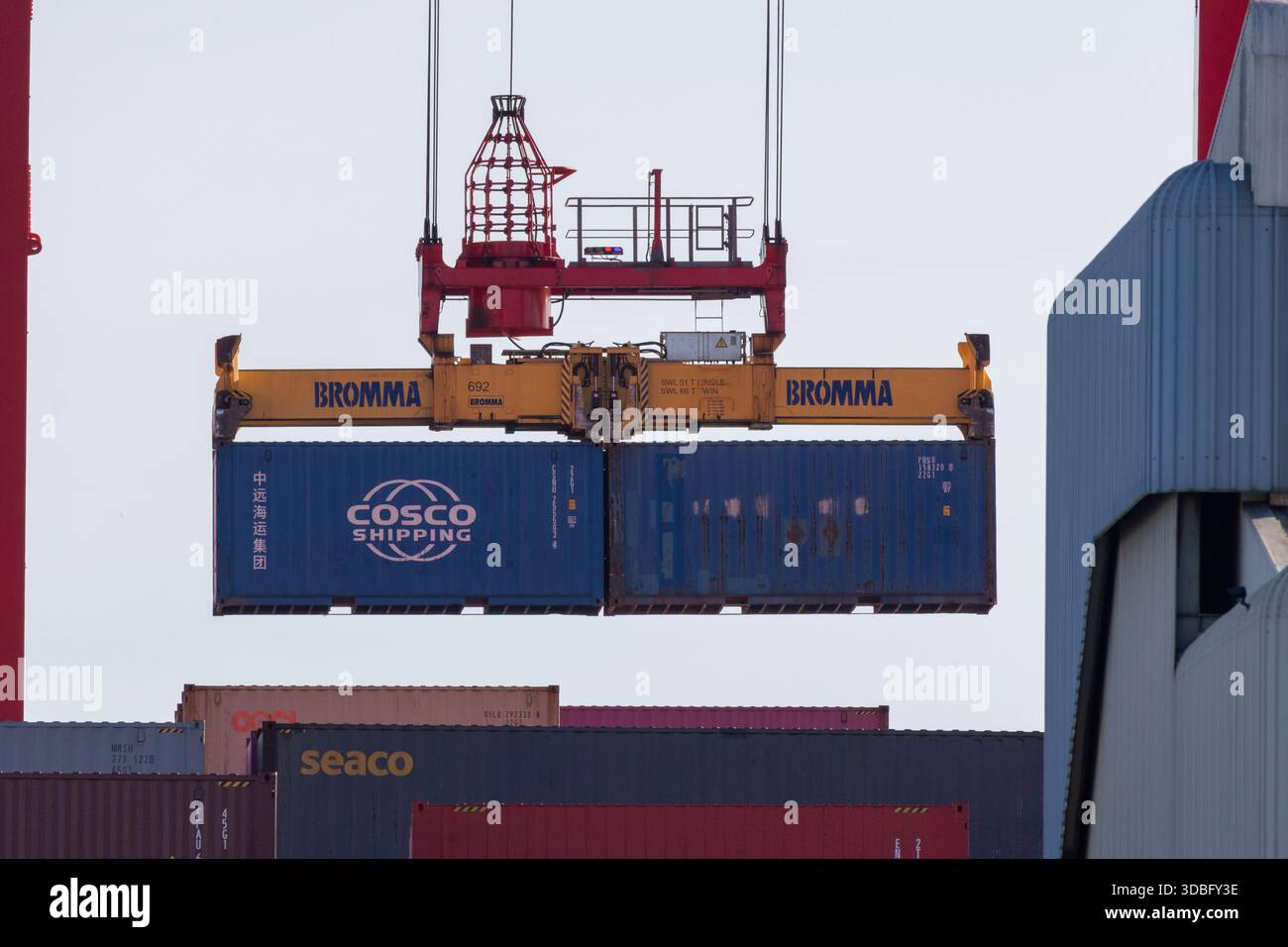 Gantry crane lifting two shipping containers at the alcantara maritime ...