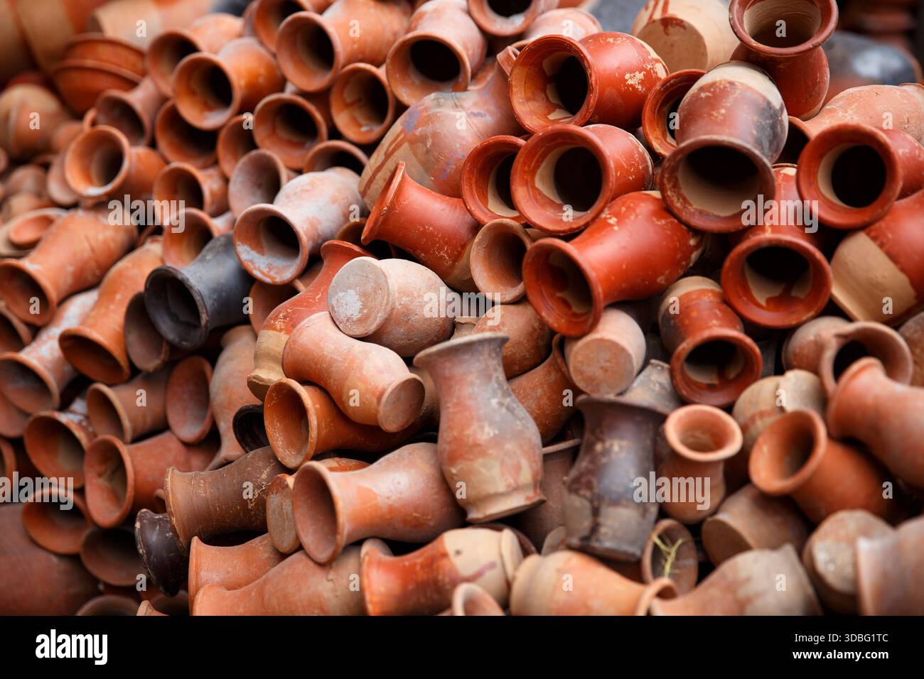 Stack of handmade terracotta pottery displayed at a local market in ...