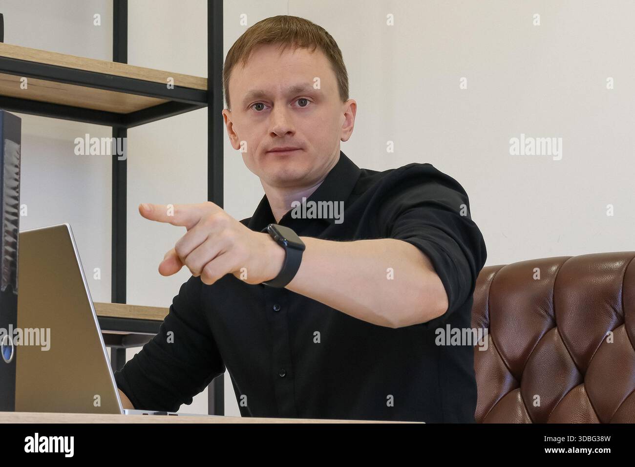Assertive professional male at workplace, extending index finger ...