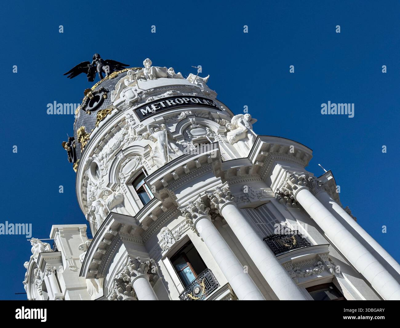 Winged statue on top of Metropolis Building , early 20th-century landmark located at the corner of Gran Vía and Calle de Alcalá in Madrid. - Smartphone Captured Stock Image