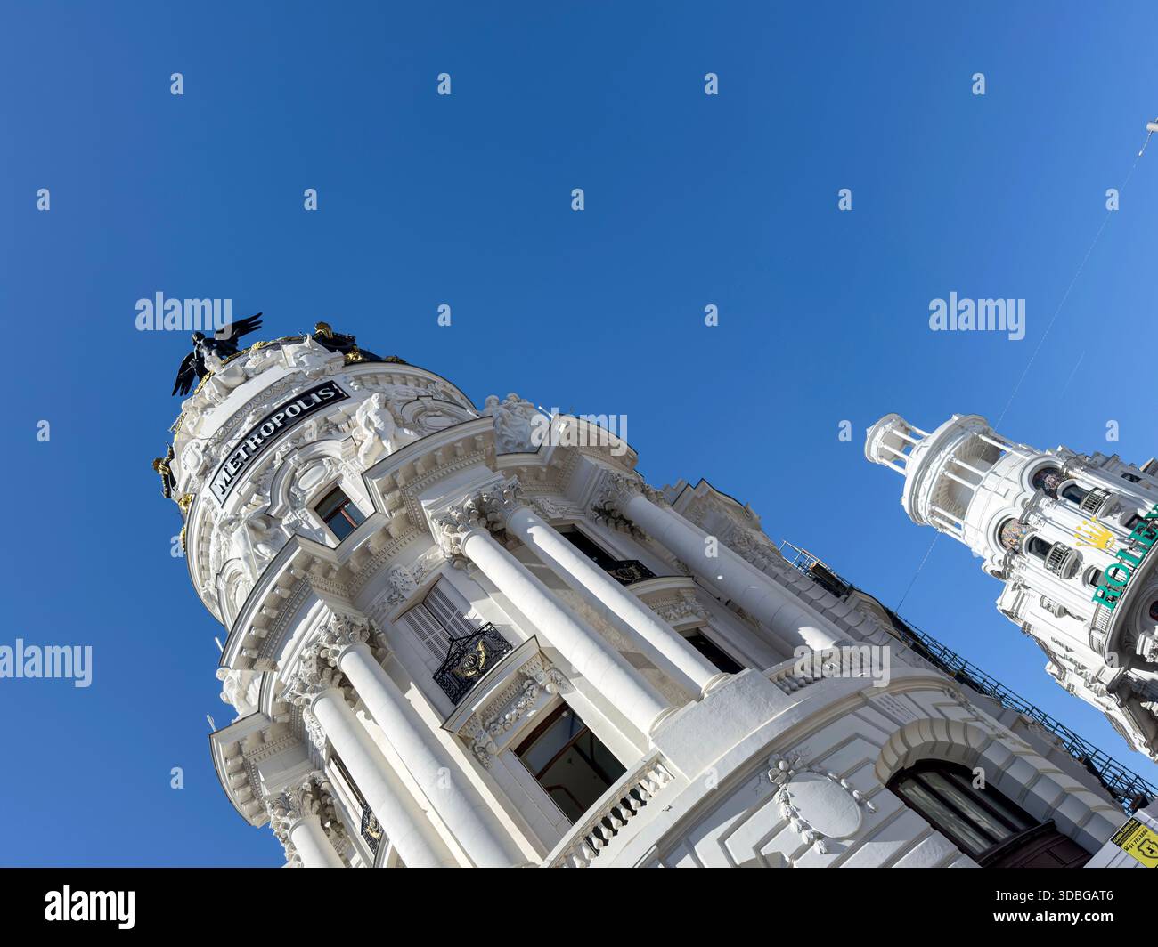 Winged statue on top of Metropolis Building , early 20th-century landmark located at the corner of Gran Vía and Calle de Alcalá in Madrid. - Smartphone Captured Stock Image