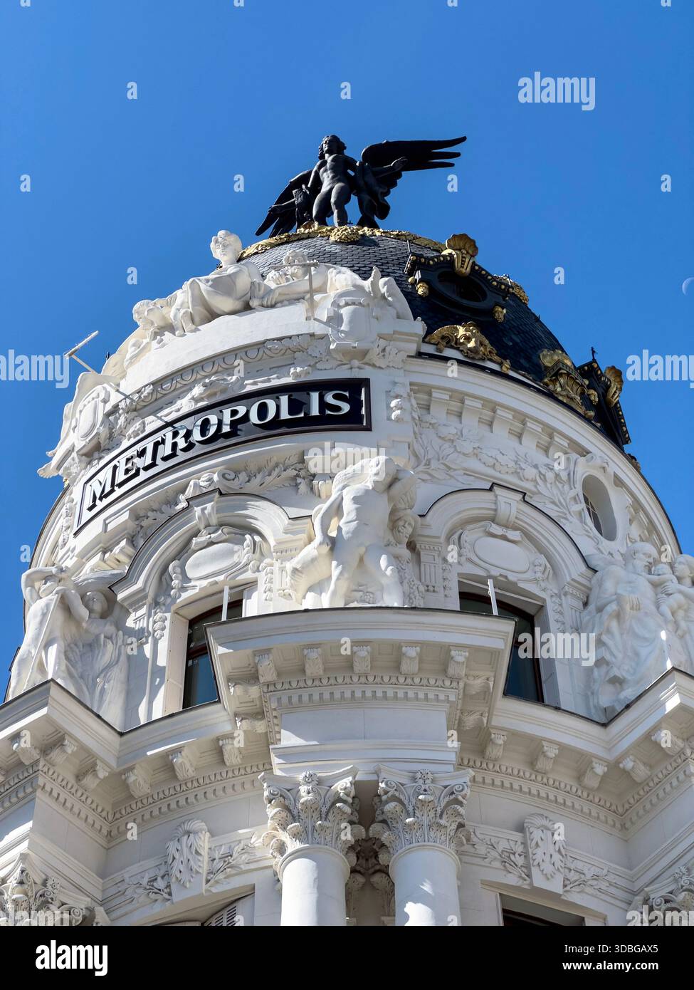 Winged statue on top of Metropolis Building , early 20th-century landmark located at the corner of Gran Vía and Calle de Alcalá in Madrid. - Smartphone Captured Stock Image