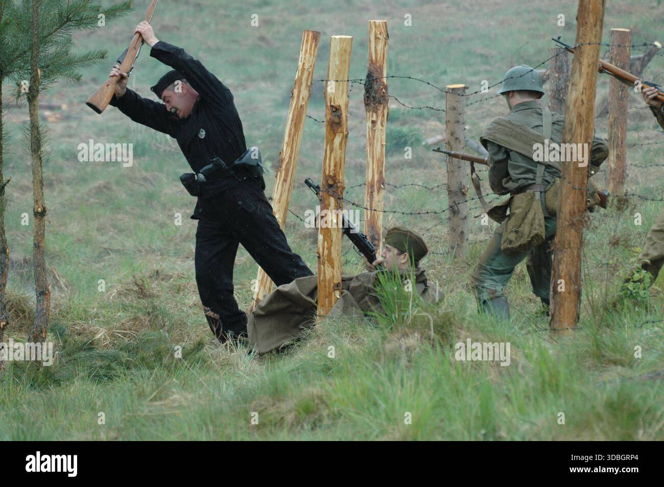 Soviet Red Army soldier attacking enemy near barbed wire during World War II reenactment, Sanok, Poland. Stock Photo