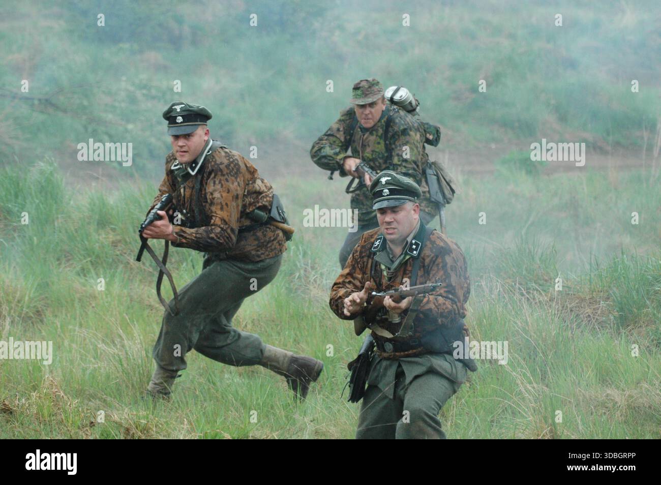 German Wehrmacht infantry attacking enemy positions during World War II reenactment of Operation Barbarossa, Sanok, Poland. Stock Photo