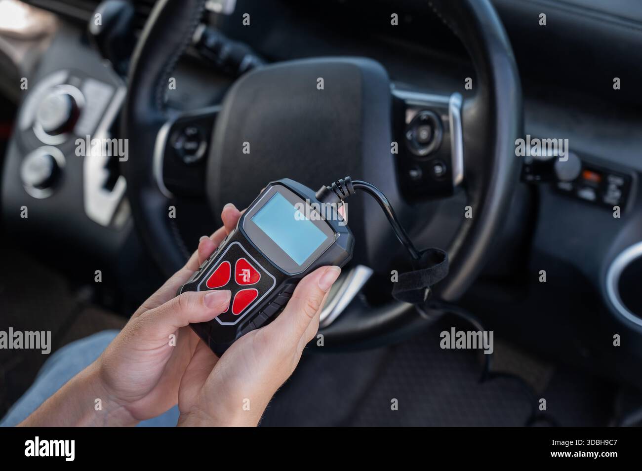 Woman using OBD2 diagnostic scanner.  Stock Photo