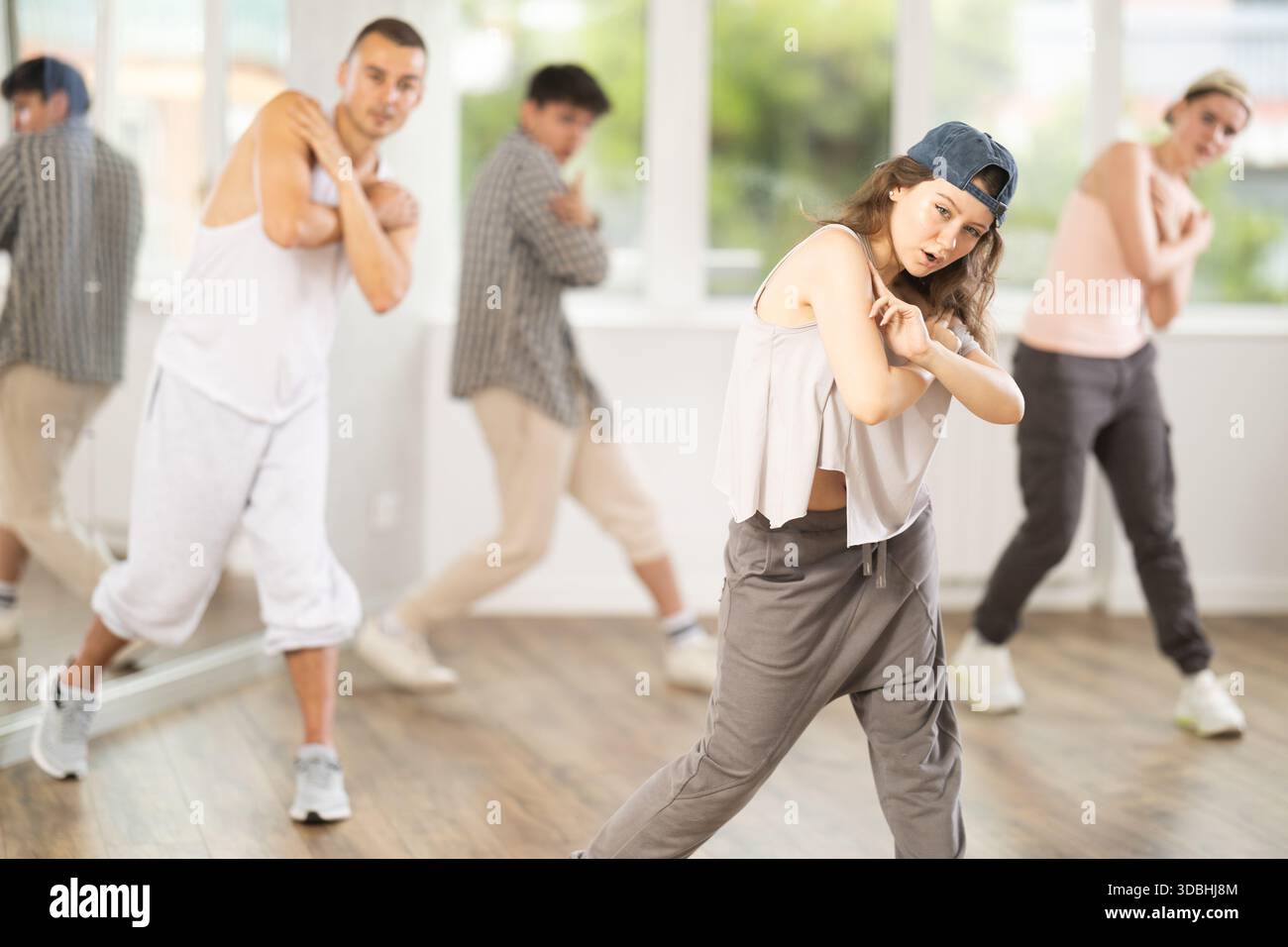 Group of young hip-hop dancers rehearsing in studio. Dancers full of ...