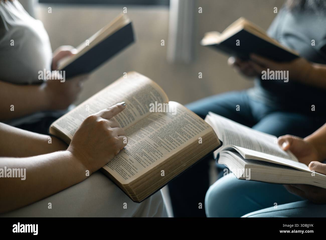 Religous Connection Group of Christian women sat together in chairs, holding their Bibles ...
