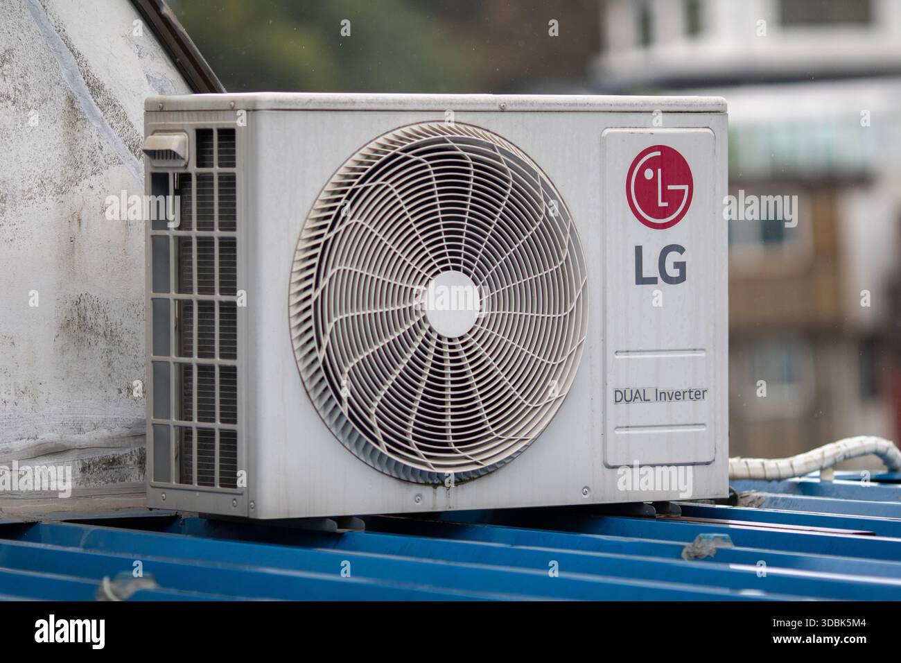 LG Heat pump Dual inverter on a blue roof Stock Photo