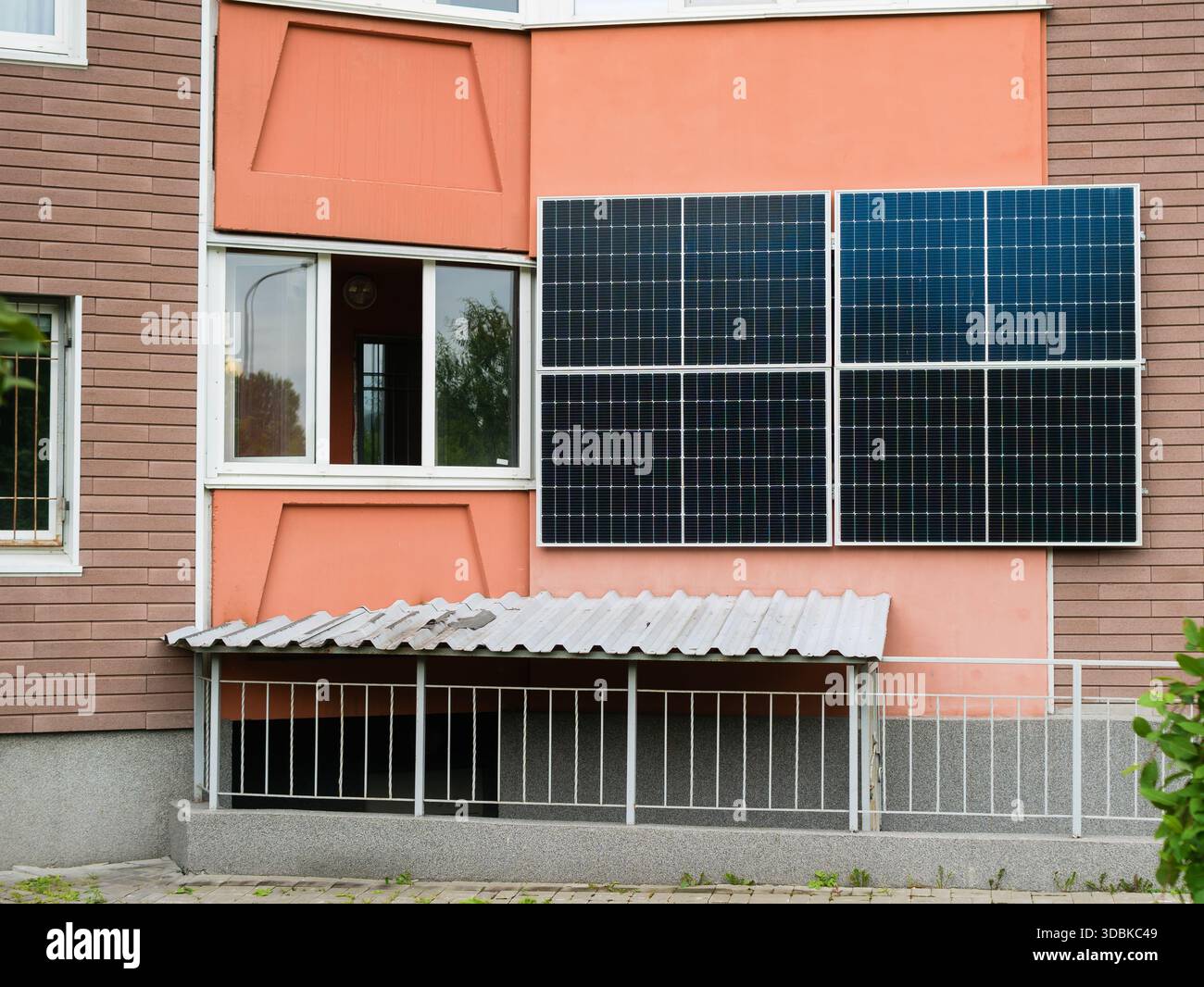 Image showcasing Solar energy panels installed on the exterior wall of a multi-unit ...