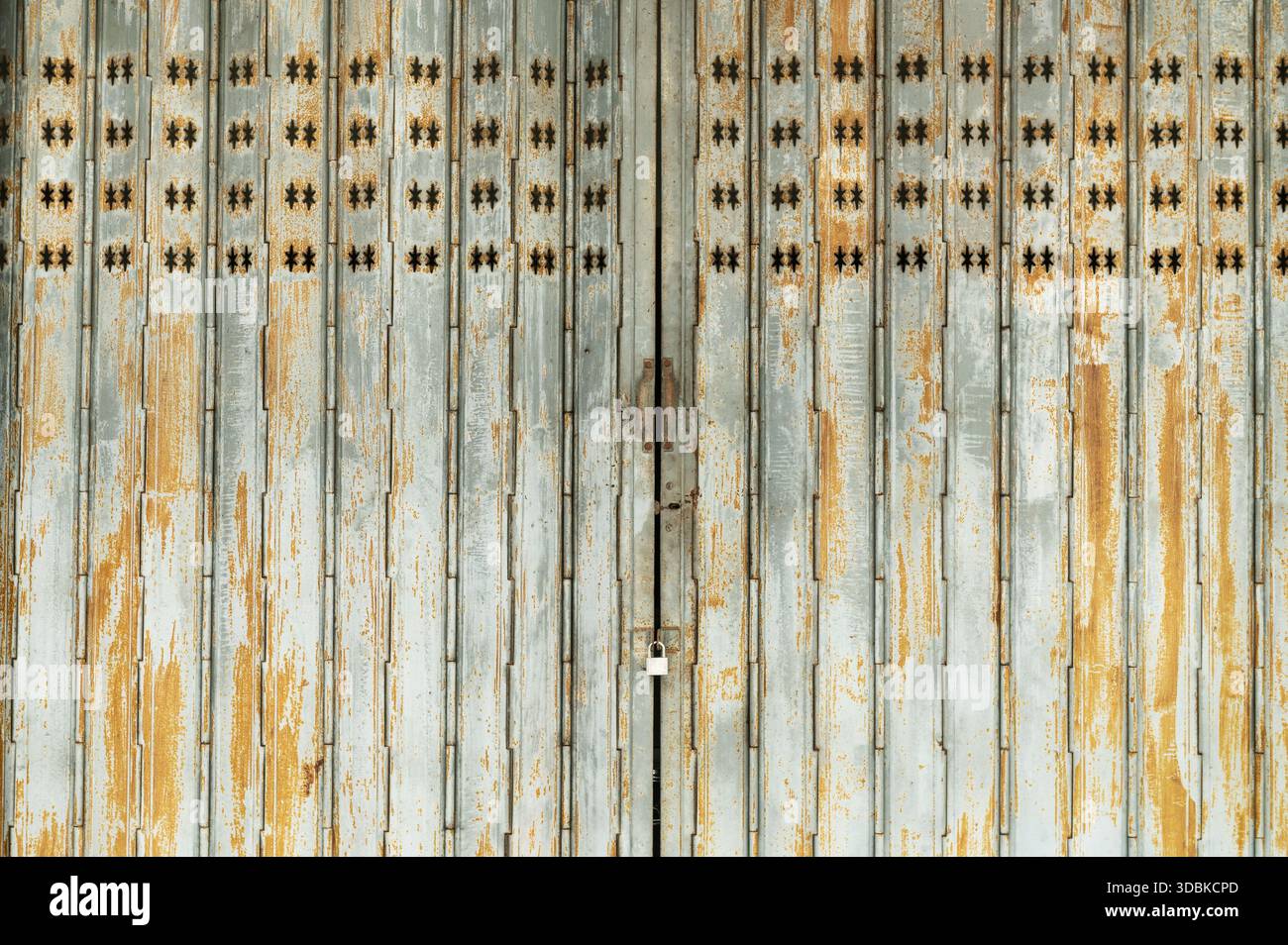 Vintage rusty folding door with star pattern cutouts Stock Photo