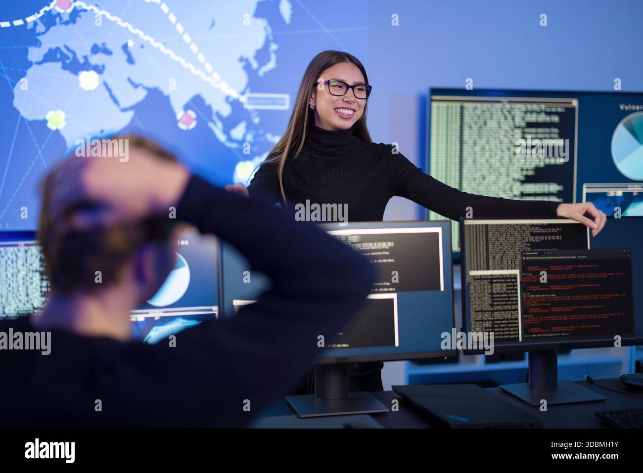 Team analyzing cybersecurity threats in modern security operations center Stock Photo