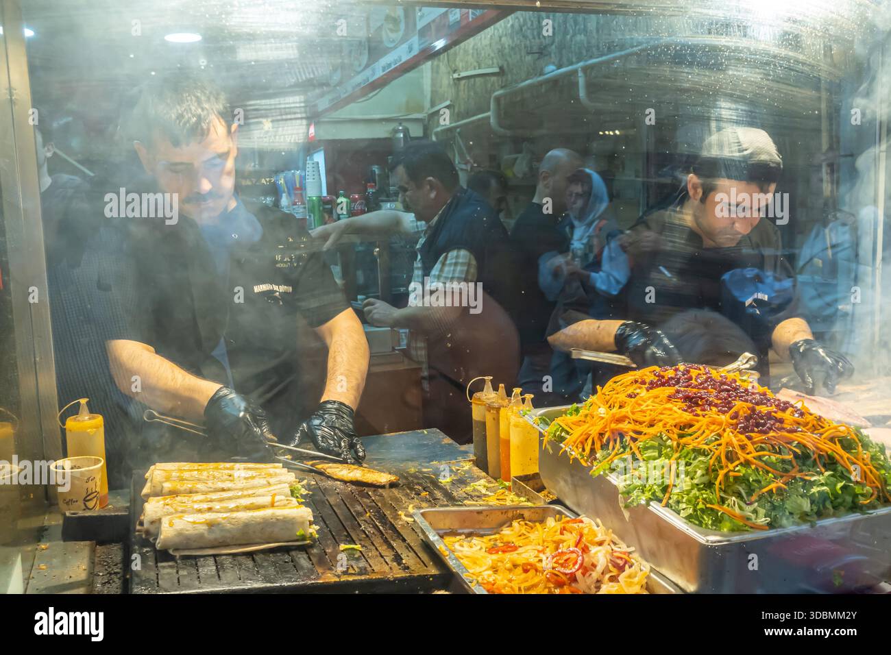 busy street food stall, Istanbul, Turkey,  chefs are preparing fresh wraps Stock Photo