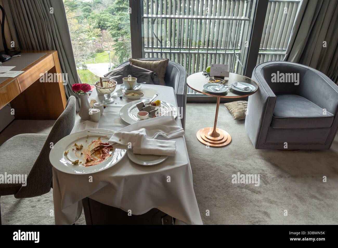 In-room dining service in a luxury hotel room after guests have finished their meal. silverware and dishware, a standard for luxury in-room dining Stock Photo