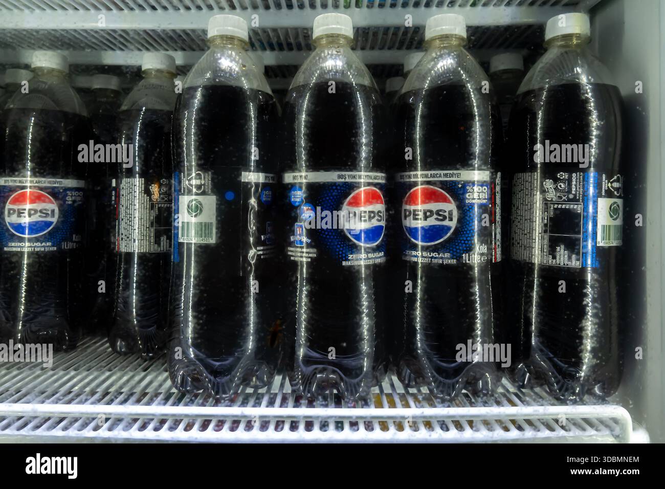 several large plastic bottles of Pepsi cola displayed in a refrigerated case. Turkey Stock Photo