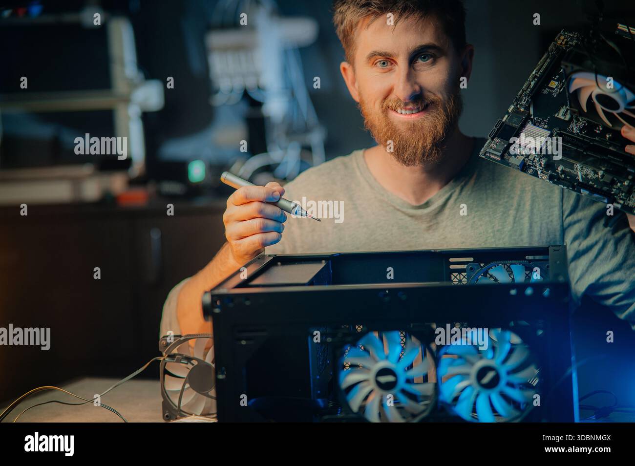 Man assembles a computer system unit at home Stock Photo
