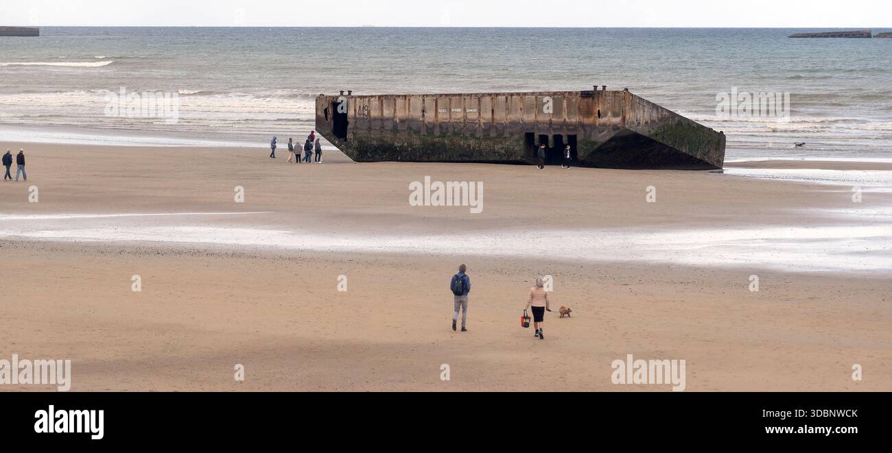 Phoenix caissons concrete blocks from D-Day still lie on the beach at Arromanches-les -Bains in Normandy, France Stock Photo