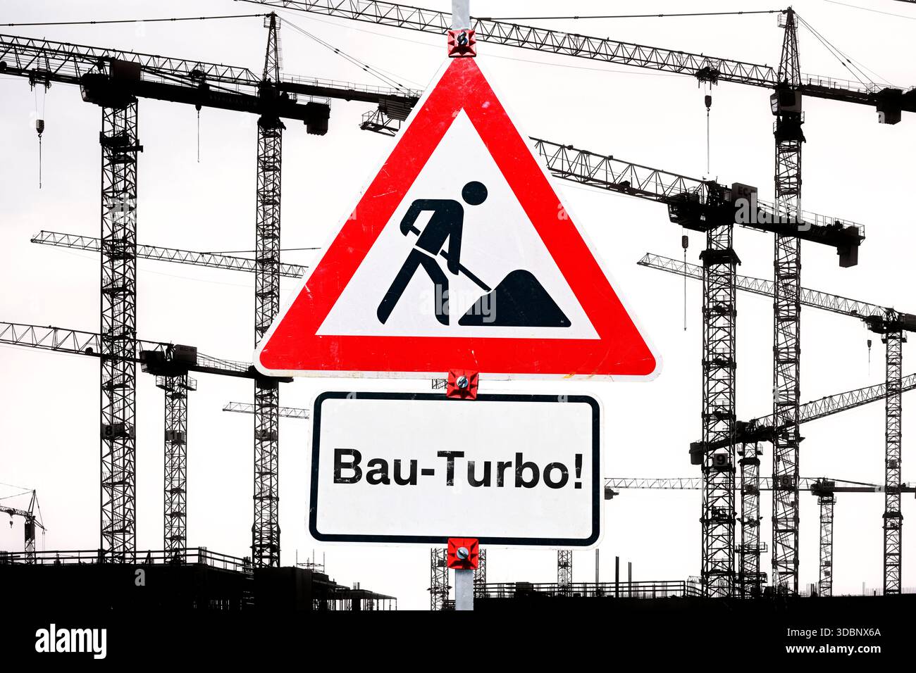 Sign with inscription bau turbo in front of construction cranes hi-res ...