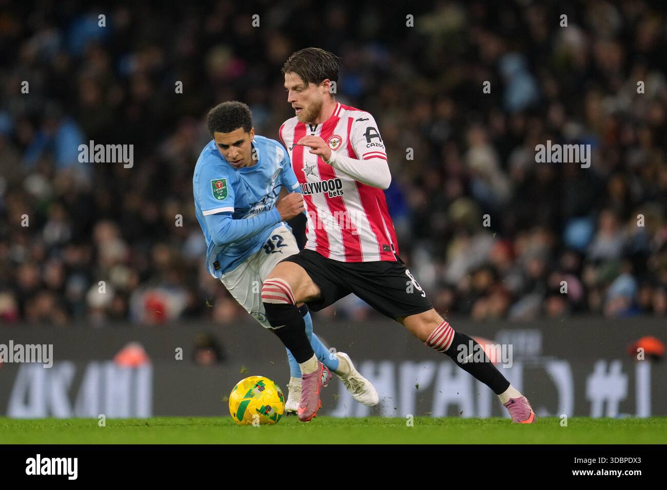 Lewis Mathias Manchester City's Rico Lewis, left, challenges for the ball with ...