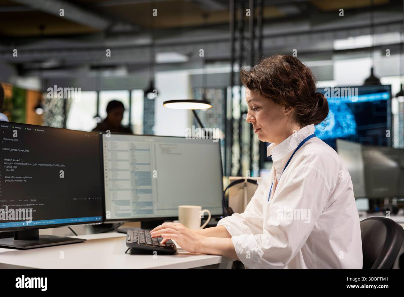 System administrator in Silicon Valley company office developing software apps. IT professional using computer at work to do coding, debugging applications to resolve issues Stock Photo