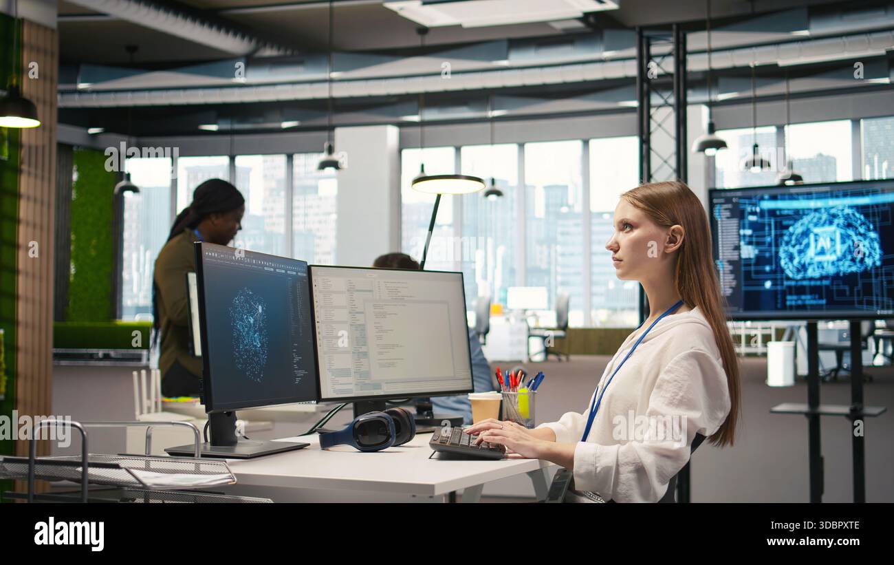 Female engineer using AI LLM chatbot, optimizing company systems performance. System administrator uses artificial intelligence assistant to convert manual workflows into automated scripts, camera A Stock Photo