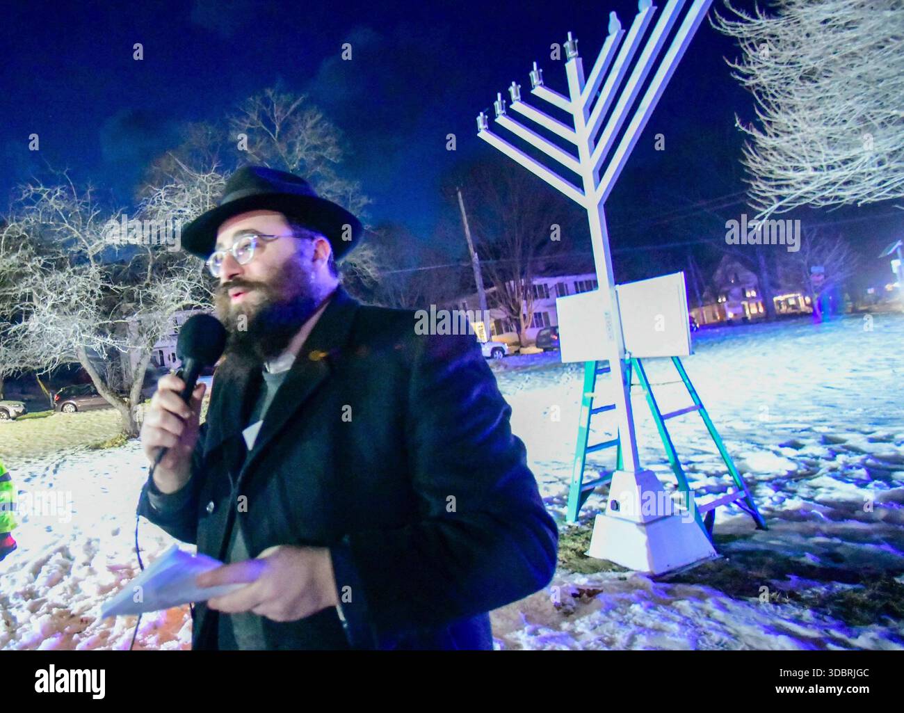 Rabbi Avremy Raskin lights the menorah as Chabad of Brattleboro hosted ...