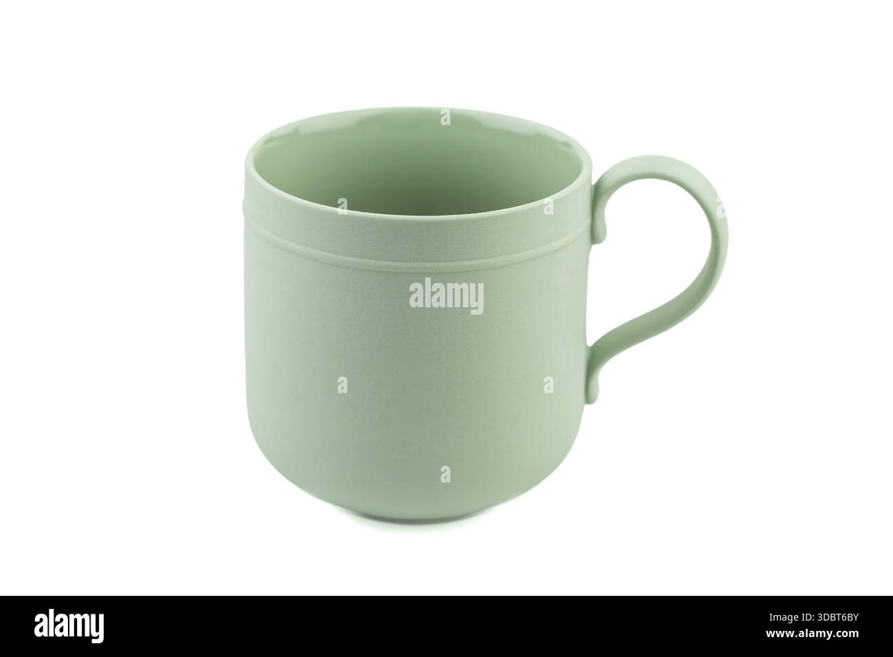 Green ceramic mug isolated on white background. Stock Photo