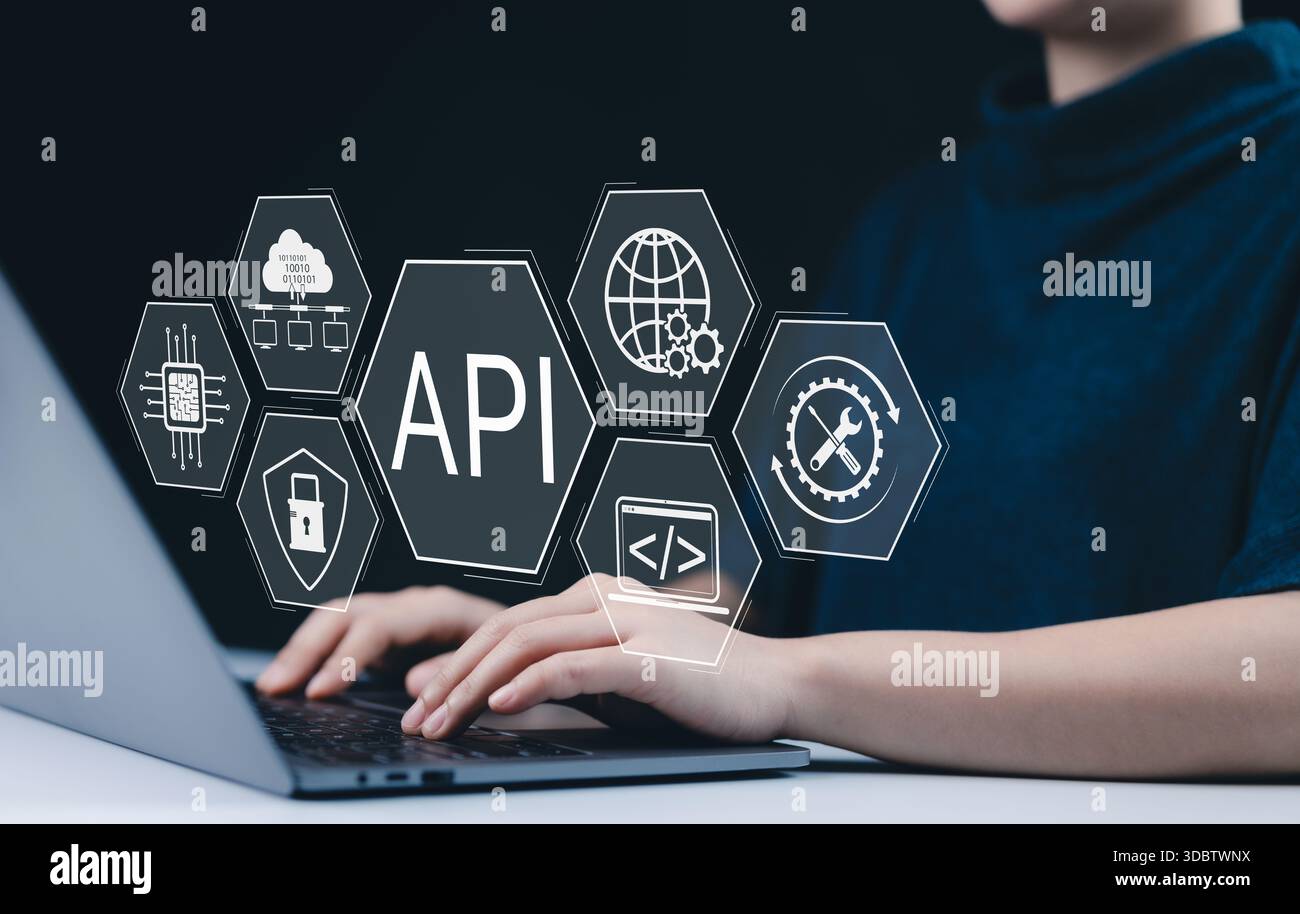 API Application Programming Interface Concept. A person types on laptop, with digital icons representing API development, security, and cloud computin Stock Photo