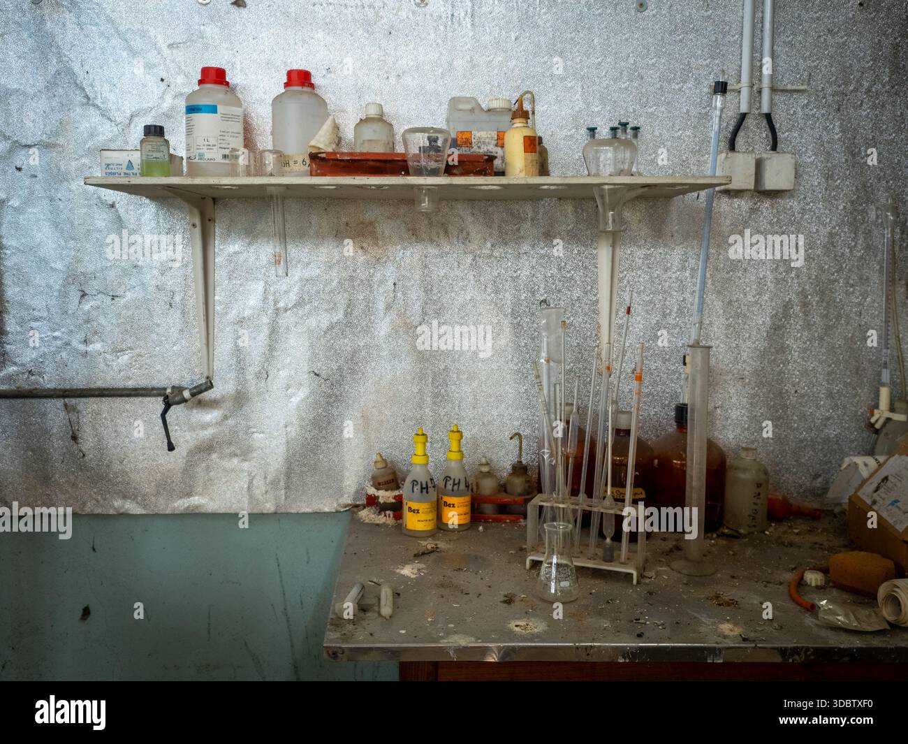Abandoned laboratory workbench with vintage glassware, chemical bottles ...