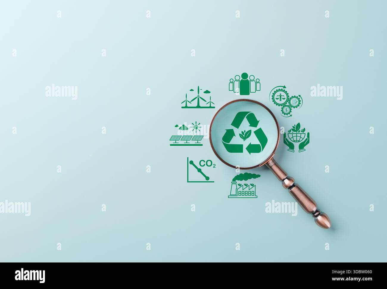 Renewable Energy and Sustainability Planning Concept. Magnifying glass focuses on green recycle icon represent renewable energy, low emissions, enviro Stock Photo
