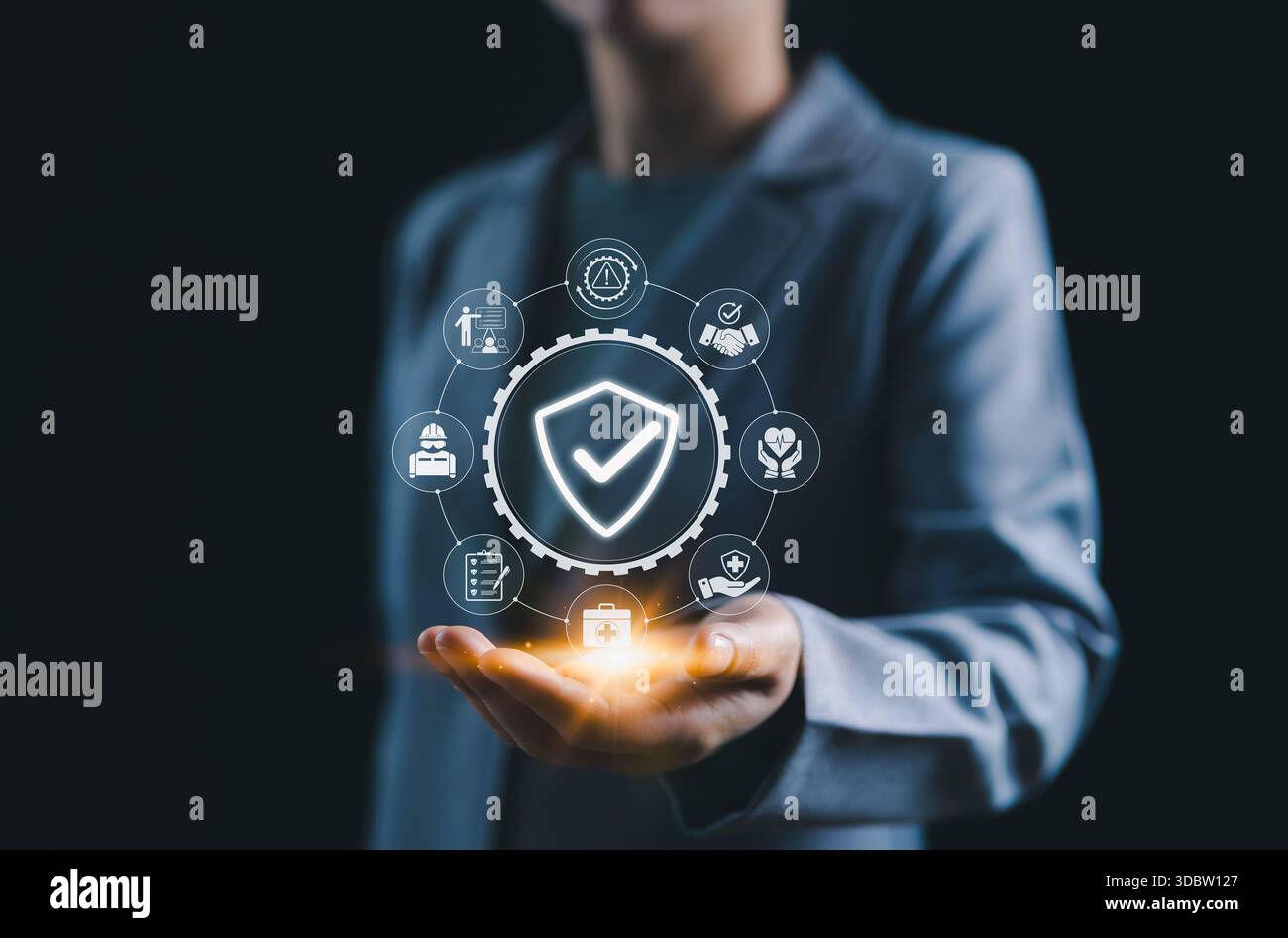 Work safety and compliance management concept. A person holds a shield ...