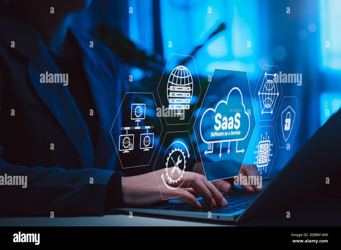 SaaS Software as a Service Cloud Computing Technology. Hands typing on laptop with SaaS icons, cloud systems, data servers, network elements, IT solut Stock Photo