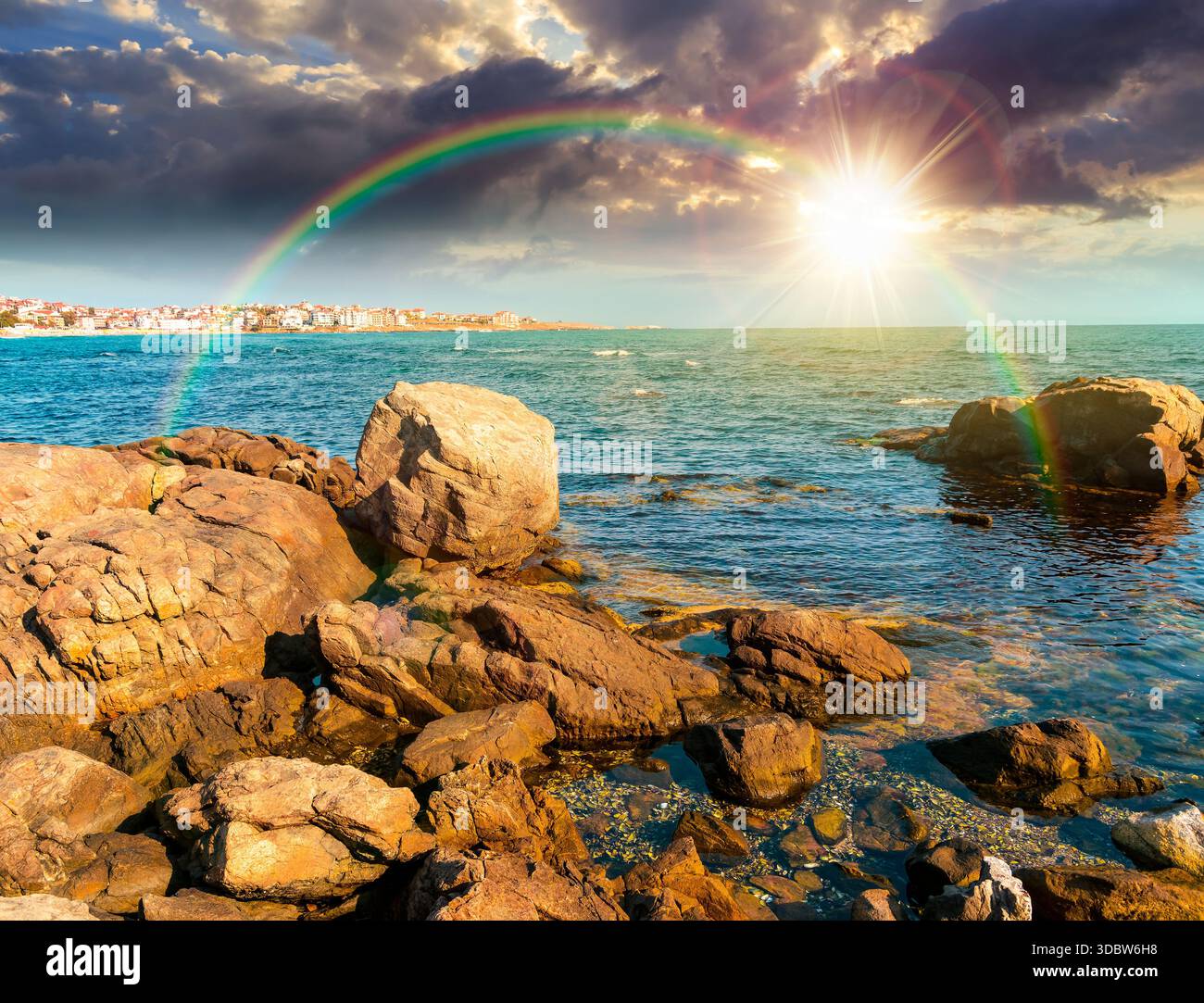 rocky shore of the sea coast under blue sky at sunset. beautiful view of coastal scene in evening light. resort scenery during vacation season in summ Stock Photo